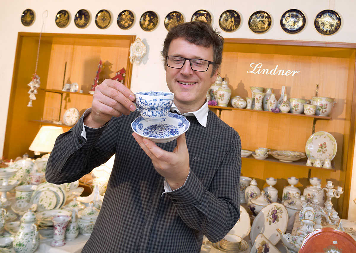 Walter Gossel, Keramtechniker und Junior, freut sich an einer Tasse im Dekor Alte Ranke Blau. Dieses Dekor ist mit Inglasur-Cobaltblau gestaltet, hoch gebrannt und damit spülmaschinenfest. Seit über 60 Jahren wird dieses zeitlose Dekor in Küps produziert – und wird gerade von jüngeren Kunden wieder besonders gern gekauft.